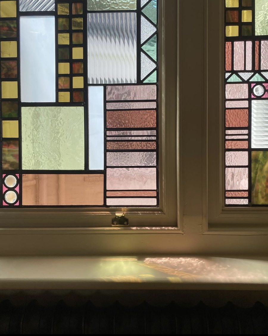 Stained glass unit set into a restored timber sash window at Kensington Court Mansions, W8